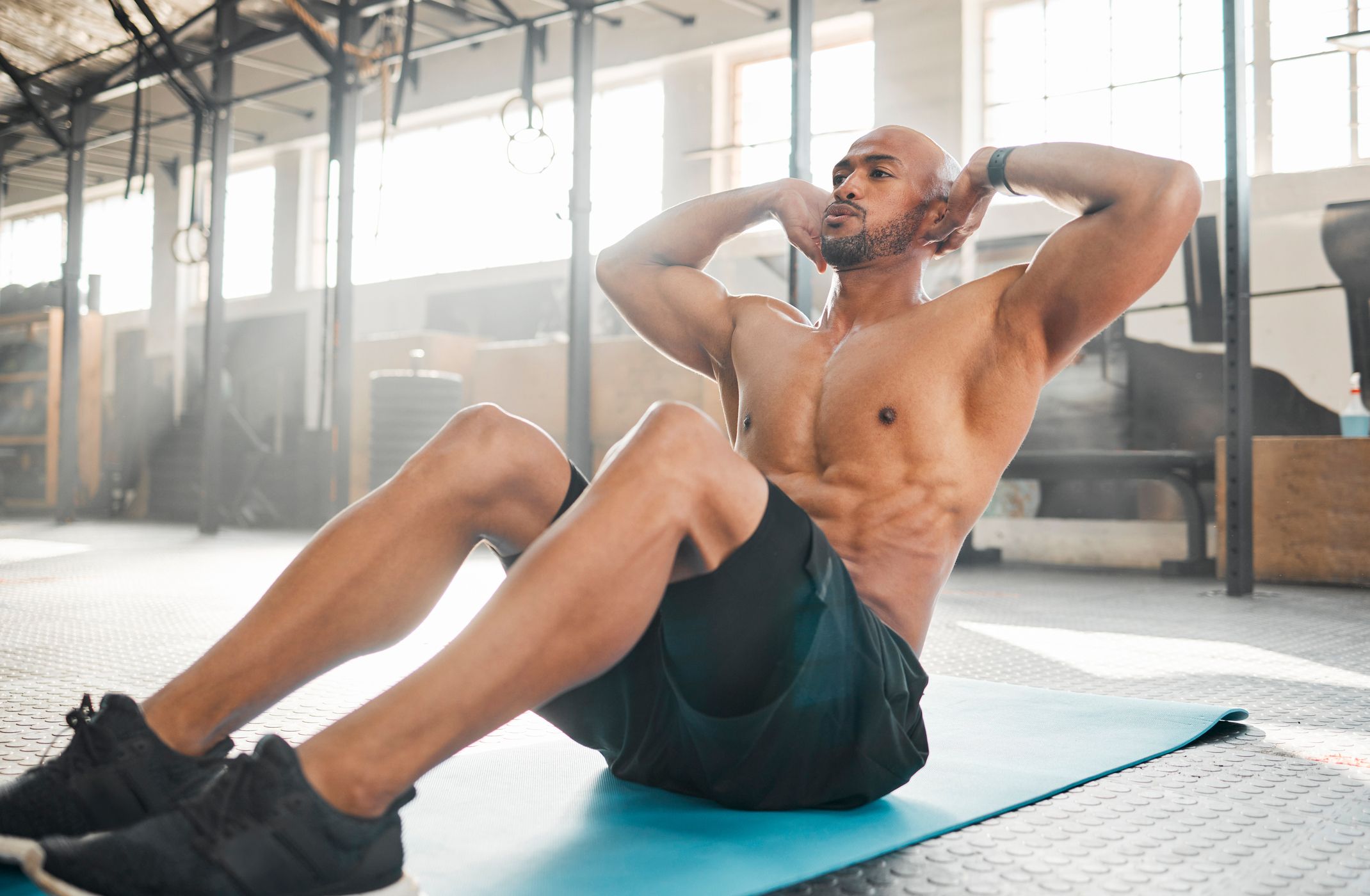 shot-of-a-young-man-completing-crunches-royalty-free-image-1678721163